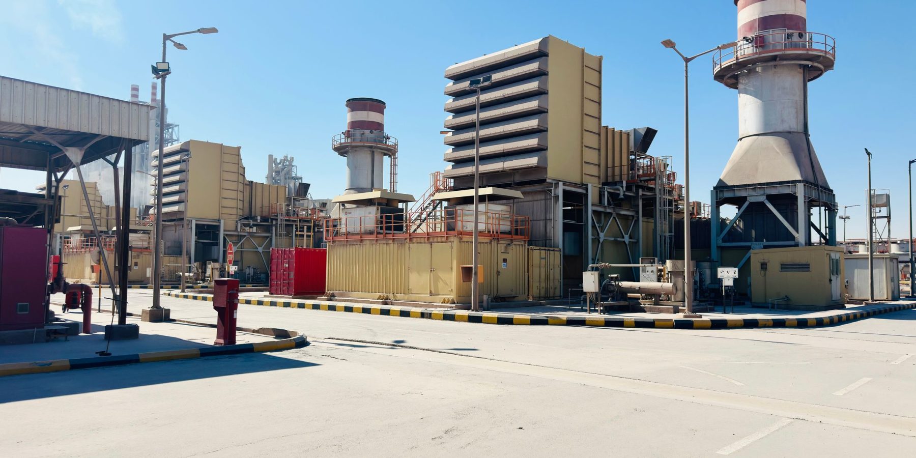 A gas turbine power generation plant under a clear sky